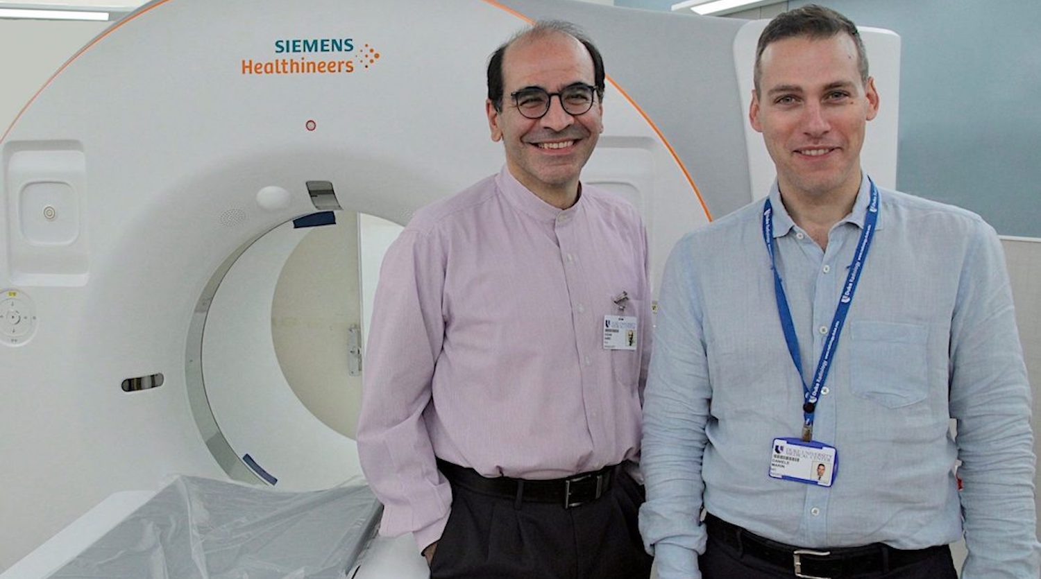Drs. Ehsan Samei and Daniele Marin stand in front of Siemens CT Scanner