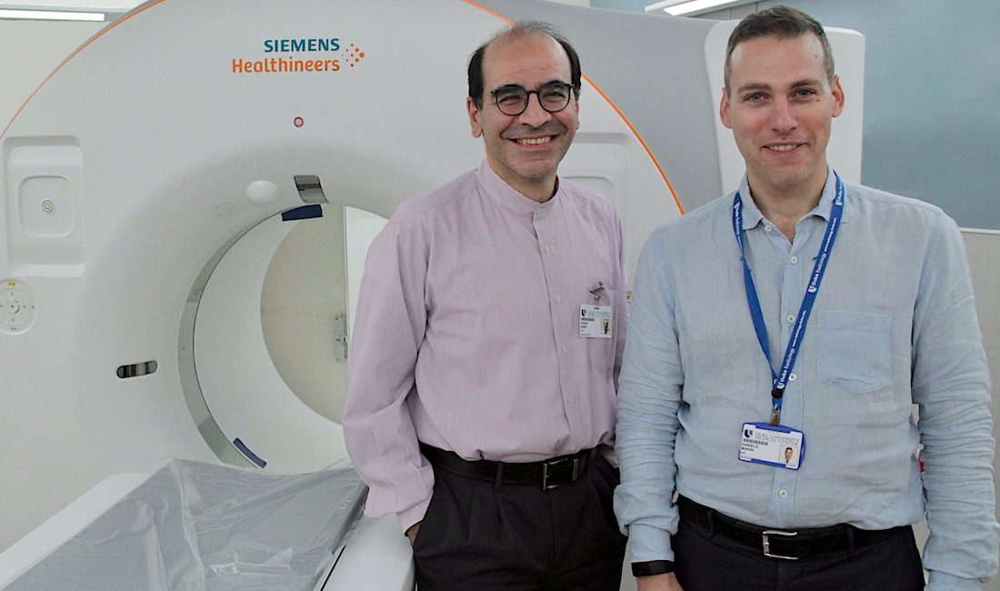 Drs. Ehsan Samei and Daniele Marin stand in front of Siemens CT Scanner